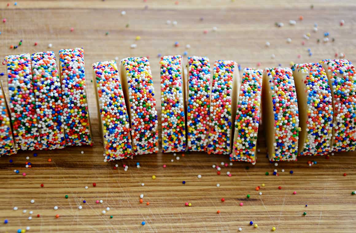A dough log with rainbow sprinkles cut into slices