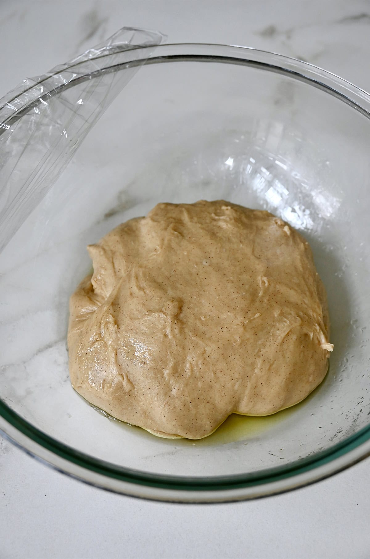 Sticky bun dough in a greased bowl, ready for its first rise.
