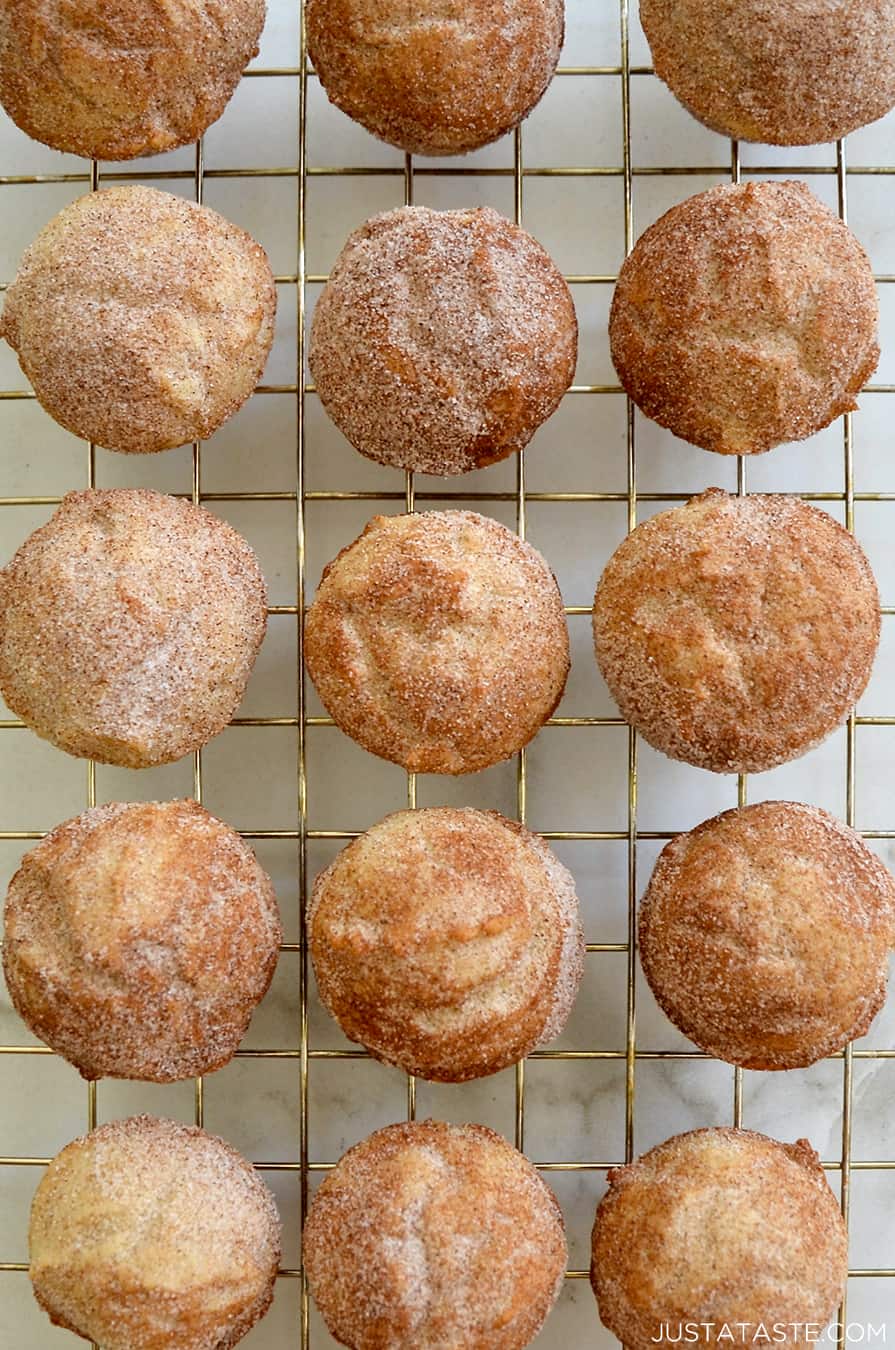 A top-down view of Mini Sour Cream Doughnut Muffins on a wire cooling rack