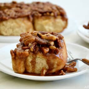 Easy Pecan Sticky Buns on serving plates with a fork
