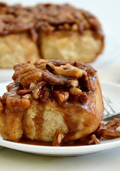 Easy Pecan Sticky Buns on serving plates with a fork