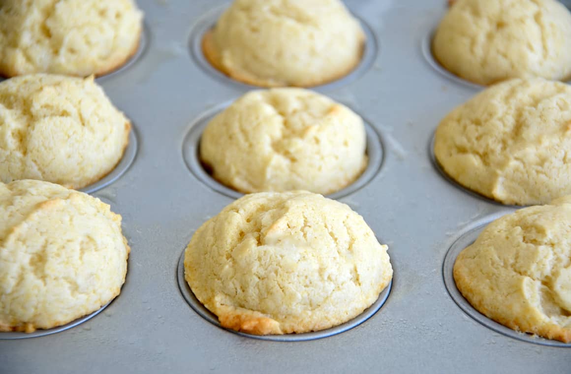 Freshly baked mini sour cream muffins in a muffin tin