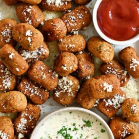 A top down view of air fryer sweet potato tots served with small bowls of Ranch and ketchup