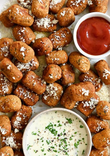 A top down view of air fryer sweet potato tots served with small bowls of Ranch and ketchup