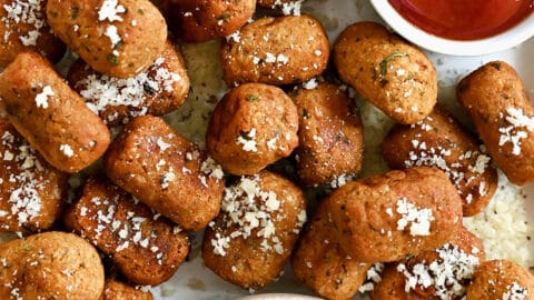 A top down view of air fryer sweet potato tots served with small bowls of Ranch and ketchup
