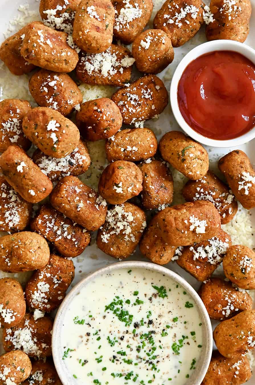 A top down view of air fryer sweet potato tots served with small bowls of Ranch and ketchup