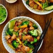 Two bowls containing Chicken and Broccoli Stir-Fry over noodles.