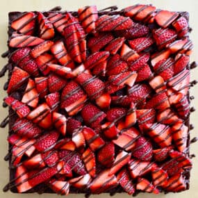 A top-down view of Chocolate-Covered Strawberry Brownies drizzled with chocolate