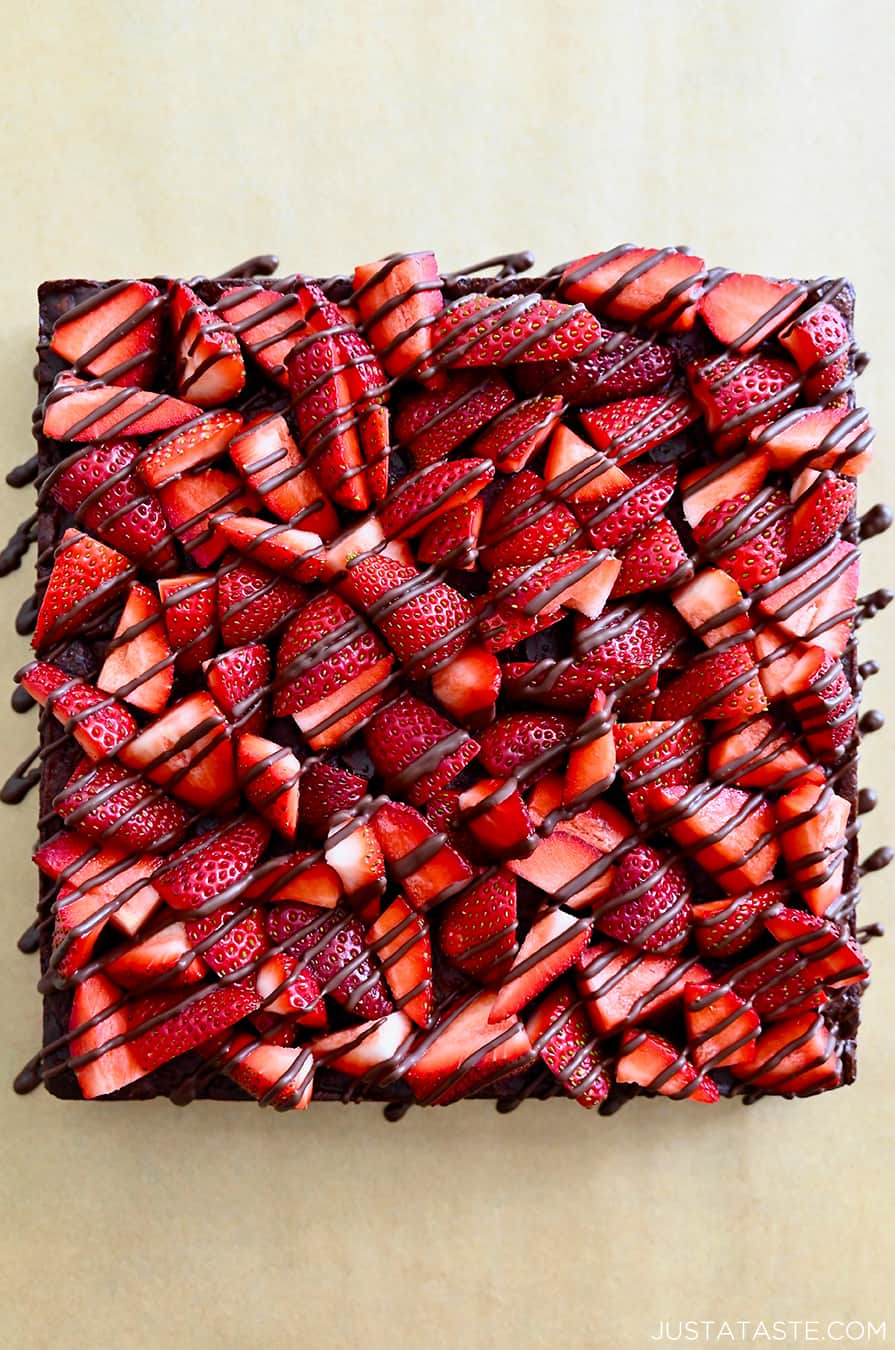 A top-down view of Chocolate-Covered Strawberry Brownies drizzled with chocolate