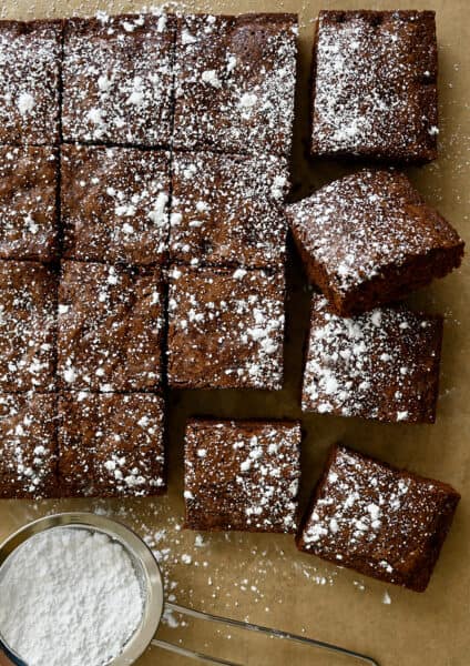 Cleanly cut brownies dusted with powdered sugar