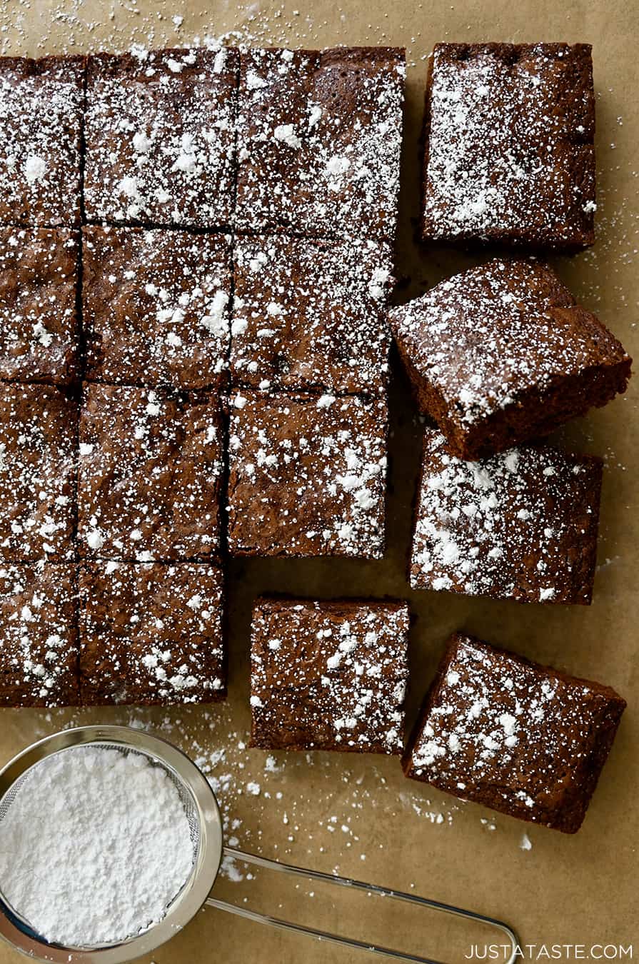 Cleanly cut brownies dusted with powdered sugar