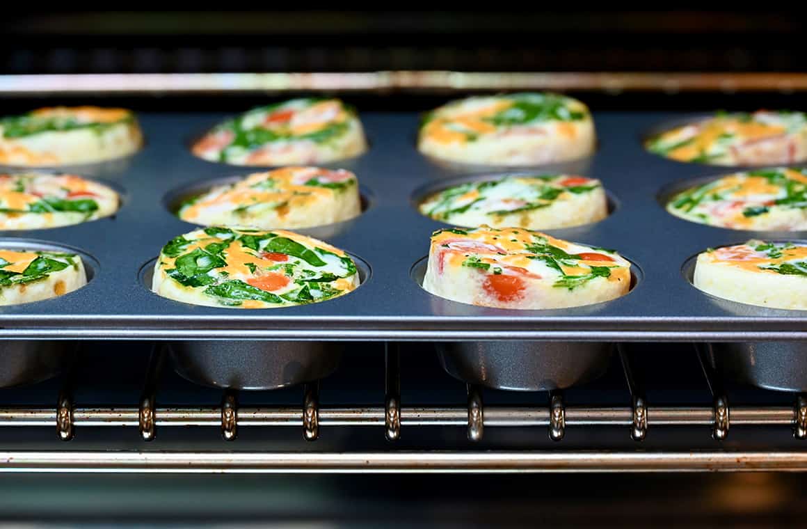 Egg white muffins on a baking rack in the oven