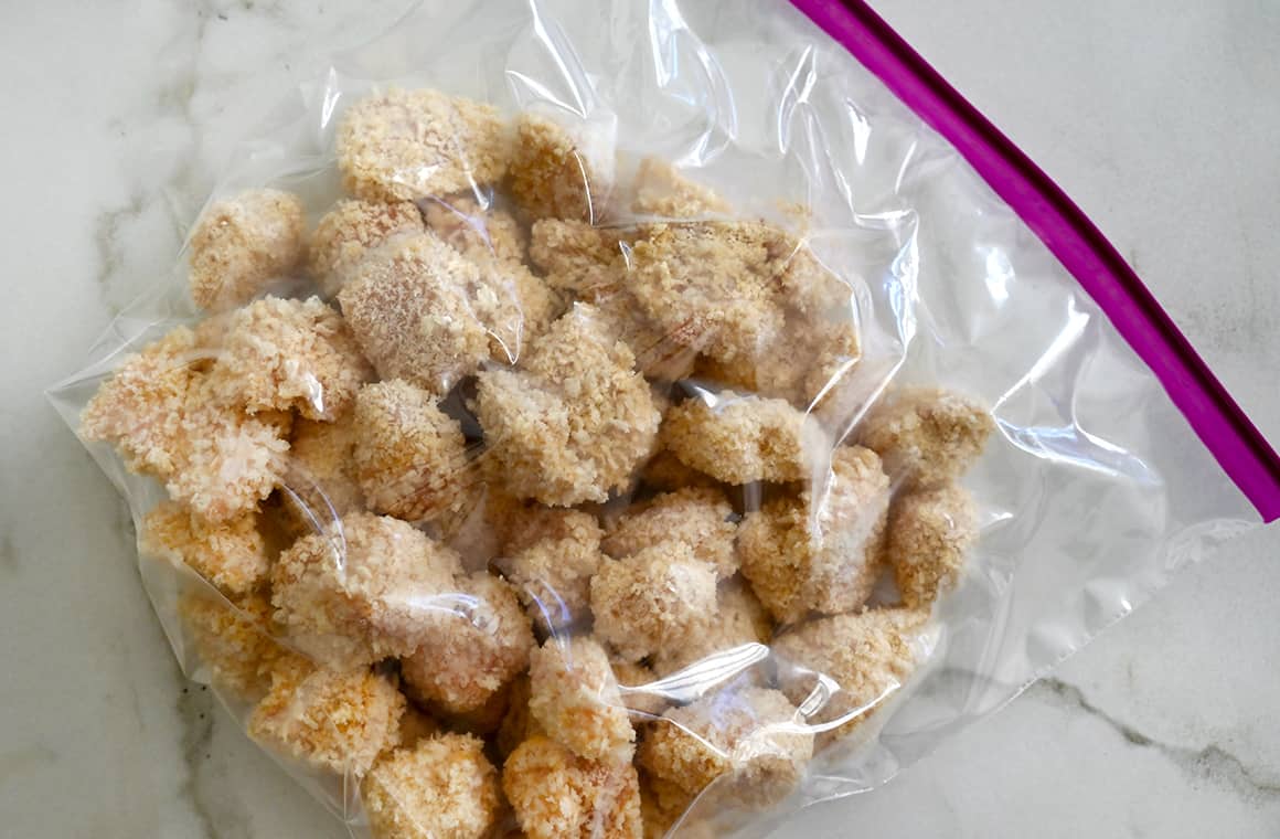 Frozen homemade chicken nuggets in a Ziploc bag