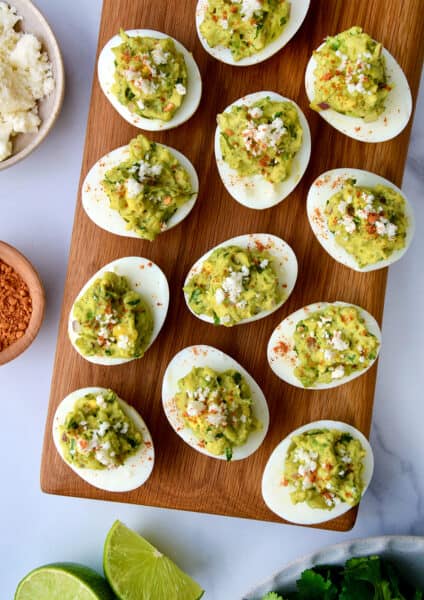 A top-down view of deviled eggs on a wooden platter