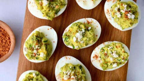 A top-down view of deviled eggs on a wooden platter