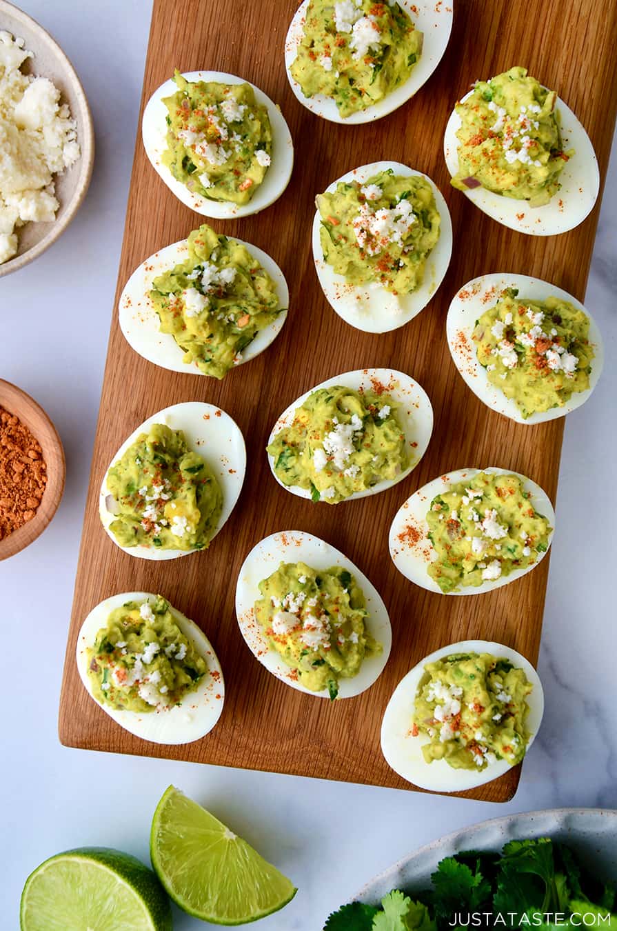 A top-down view of deviled eggs on a wooden platter