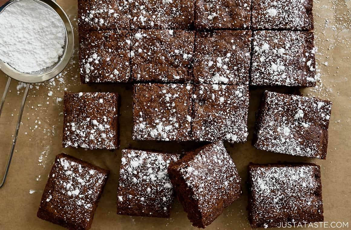 Brownies cut cleanly into squares and dusted with powdered sugar