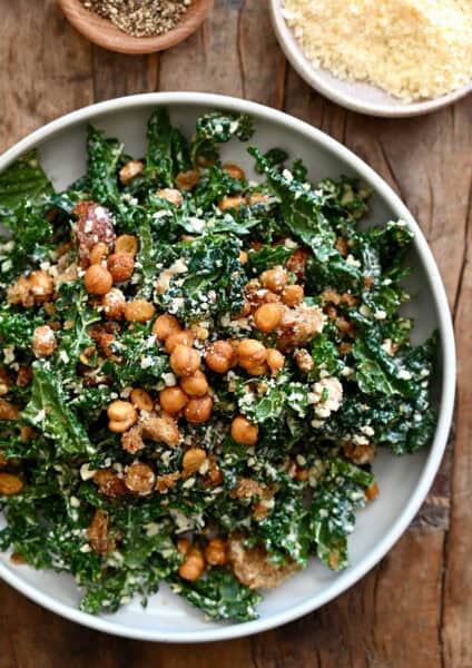 Tuscan kale Caesar salad with homemade croutons and crispy chickpeas in a large serving bowl.