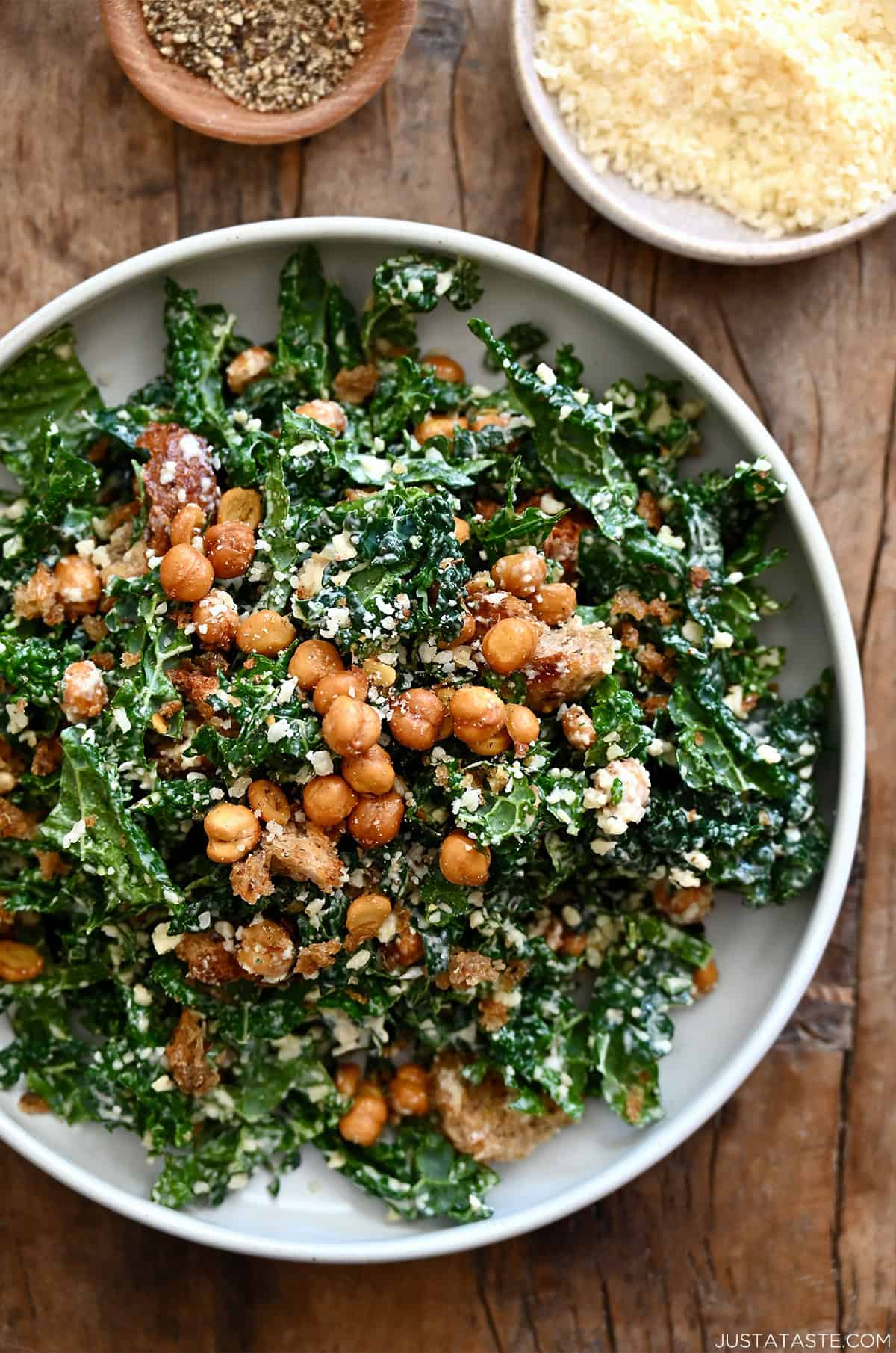 Tuscan kale Caesar salad with homemade croutons and crispy chickpeas in a large serving bowl.