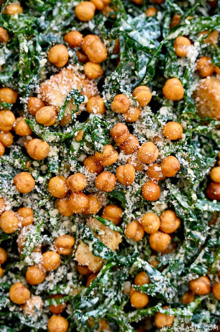 A close-up of shredded kale salad topped with grated Parmesan cheese