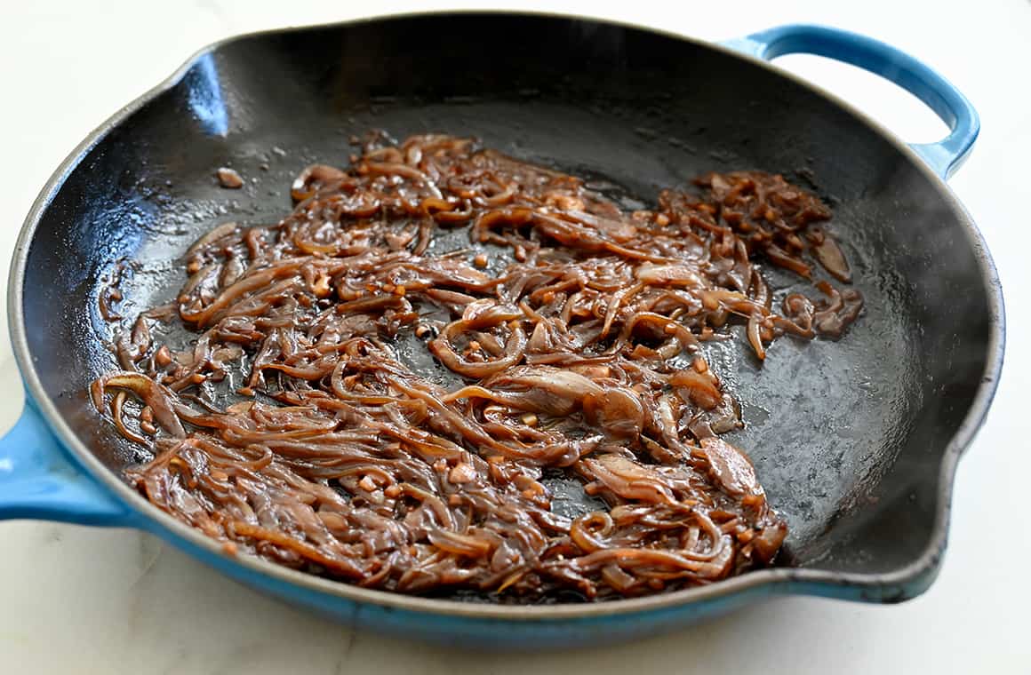 Caramelized onions in a blue Le Creuset skillet