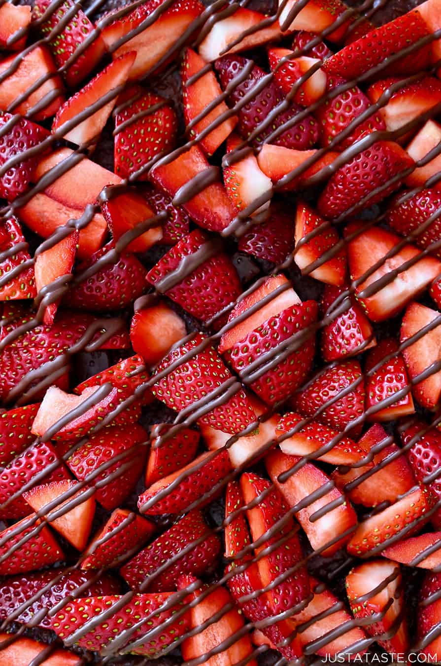 A close-up view of strawberries drizzled with chocolate