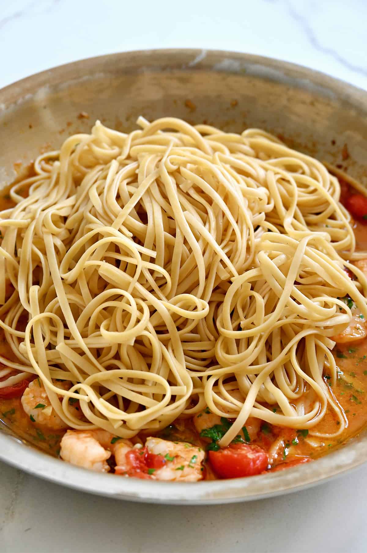 Making shrimp scampi with linguine.