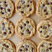 A top-down view of Blended Oatmeal Chocolate Chip Cookies on parchment paper.