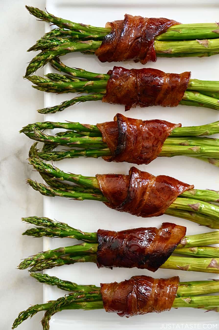 Crispy Bacon-Wrapped Asparagus Bundles on a white serving plate