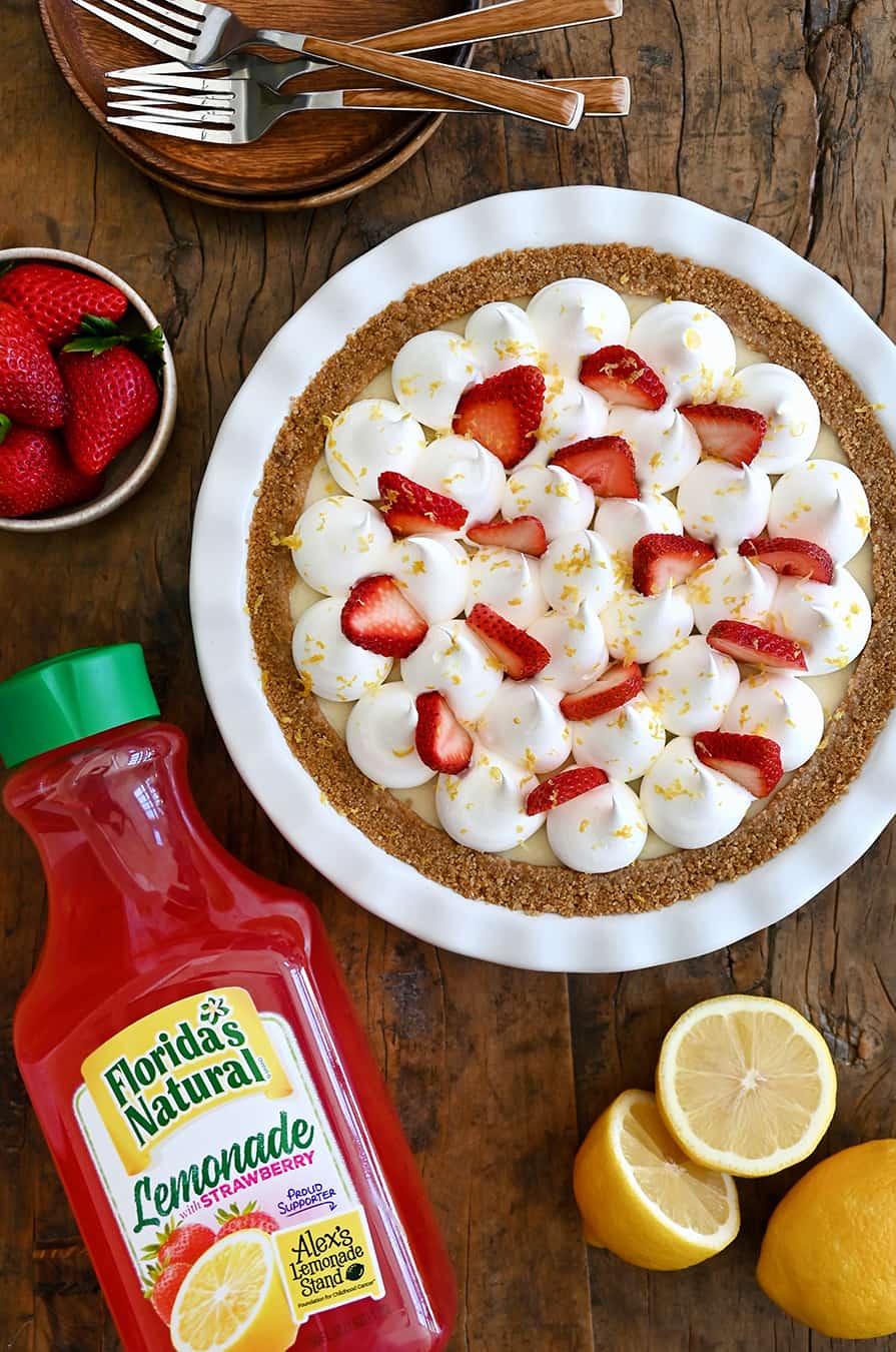 A top down view of an icebox pie with a bottle of strawberry lemonade next to it