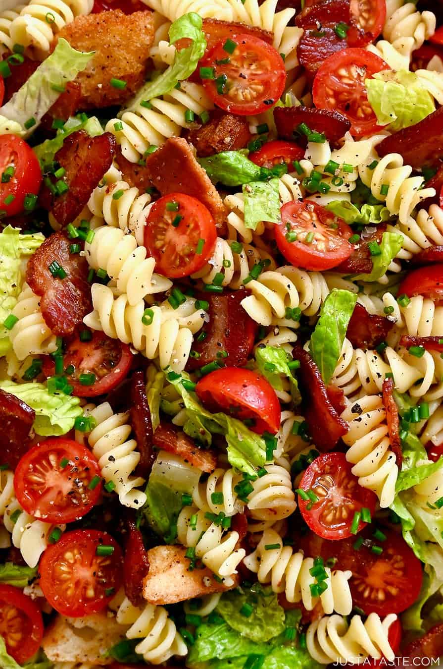 A close-up view of BLT pasta salad tossed in a red wine vinaigrette