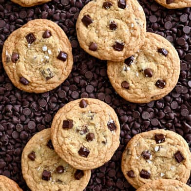 A top-down view of No-Chill Chocolate Chip Cookies atop a bed of chocolate chips