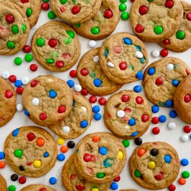 A top-down view of Soft and Chewy M&M Cookies studded with various colors of the candy-coated chocolates