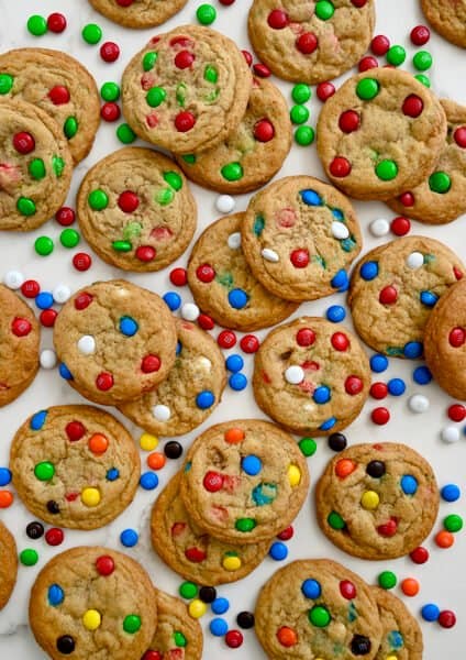 A top-down view of Soft and Chewy M&M Cookies studded with various colors of the candy-coated chocolates