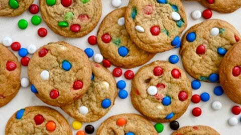 A top-down view of Soft and Chewy M&M Cookies studded with various colors of the candy-coated chocolates