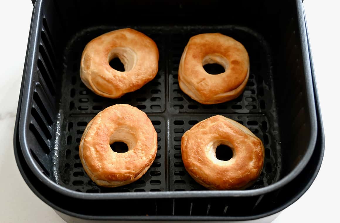 Golden brown doughnuts in the basket of an air fryer