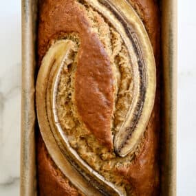 A top-down view of the best Brown Butter Banana Bread topped with two banana slices