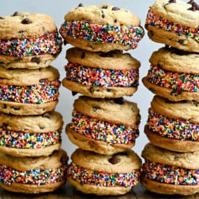 Three rows of stacked ice cream cookie sandwiches studded with rainbow sprinkles