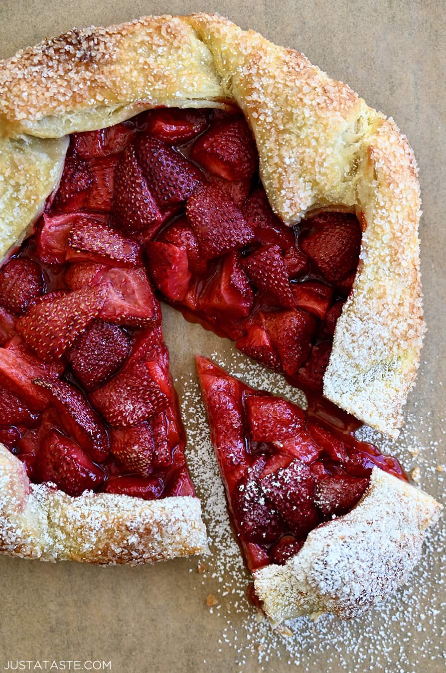 A top-down view of a strawberry puff pastry galette dusted with powered sugar
