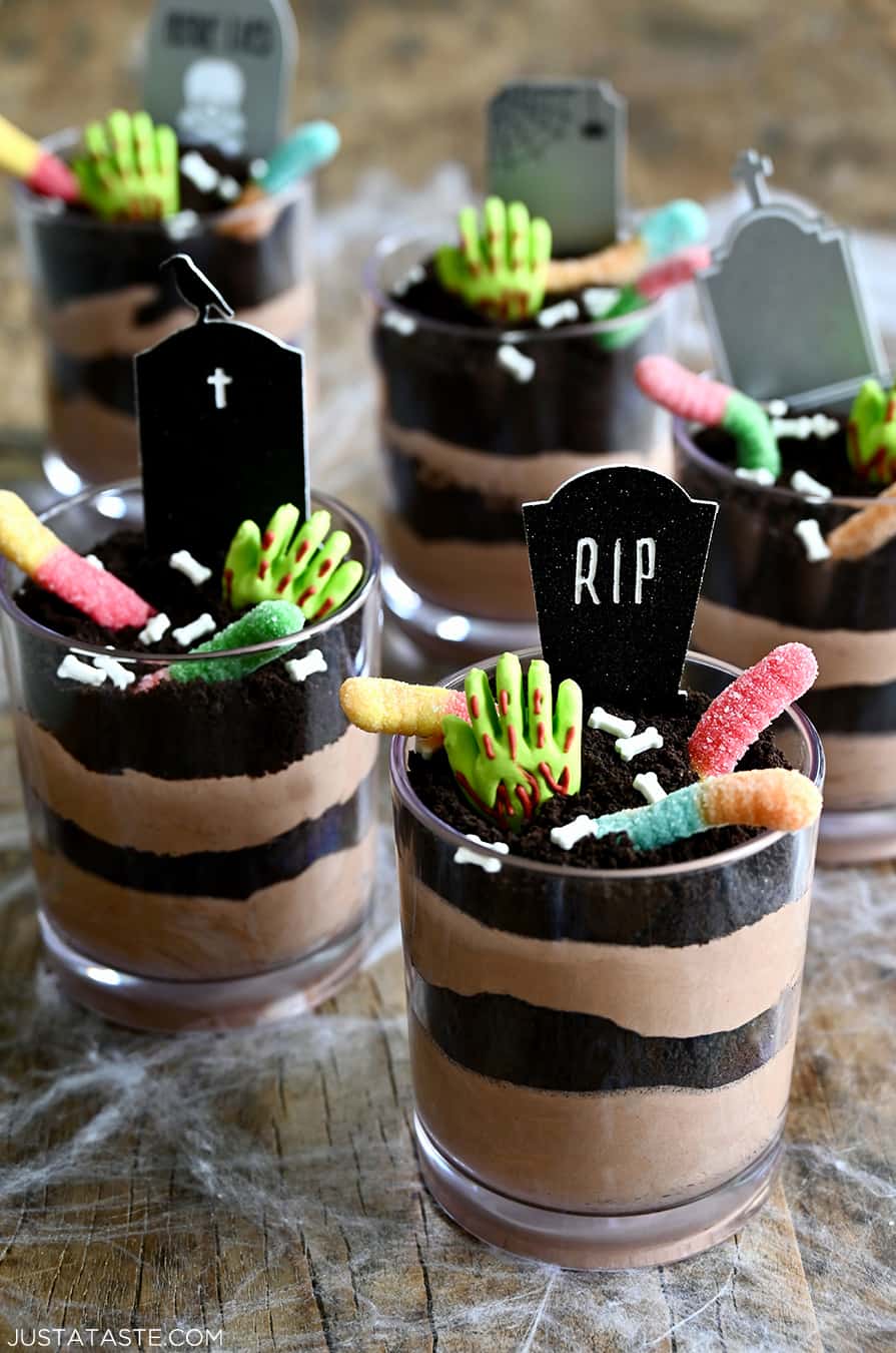 Individual Halloween Dirt Cups with gummy worms, bloody gummy hands and RIP cake toppers