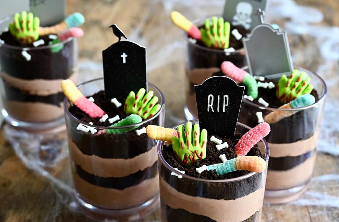 The best Halloween Dirt Cups with candy bones, candy hands, gummy worms and RIP signs