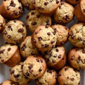 A close-up view of mini banana muffins studded with mini chocolate chips