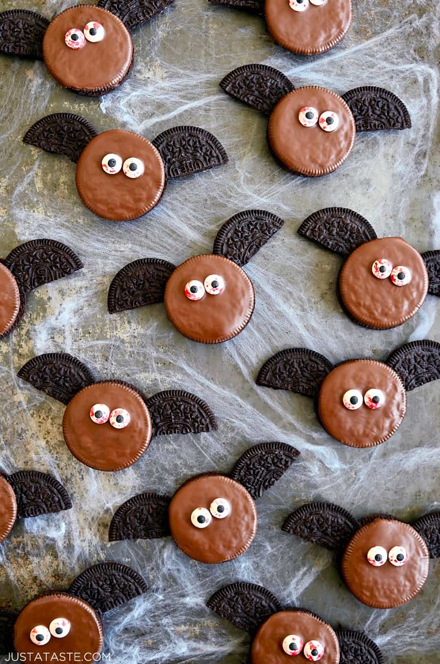 A top-down view of No-Bake Oreo Bat Cookies with bloodshot candy eyes atop fake cobwebs