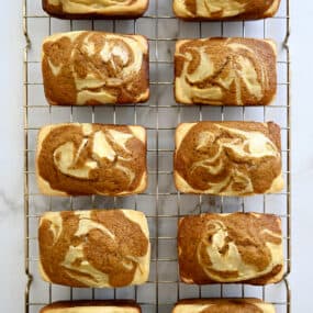 A top-down view of Pumpkin Cream Cheese Mini Loaves cooling on a wire rack