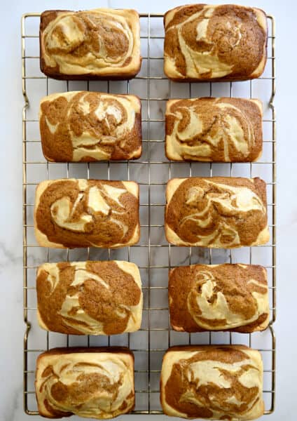 A top-down view of Pumpkin Cream Cheese Mini Loaves cooling on a wire rack