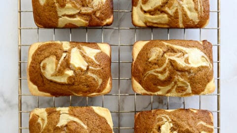 A top-down view of Pumpkin Cream Cheese Mini Loaves cooling on a wire rack