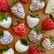 A top-down view of homemade White Chocolate-Covered Strawberries, including some decorated with rainbow sprinkles