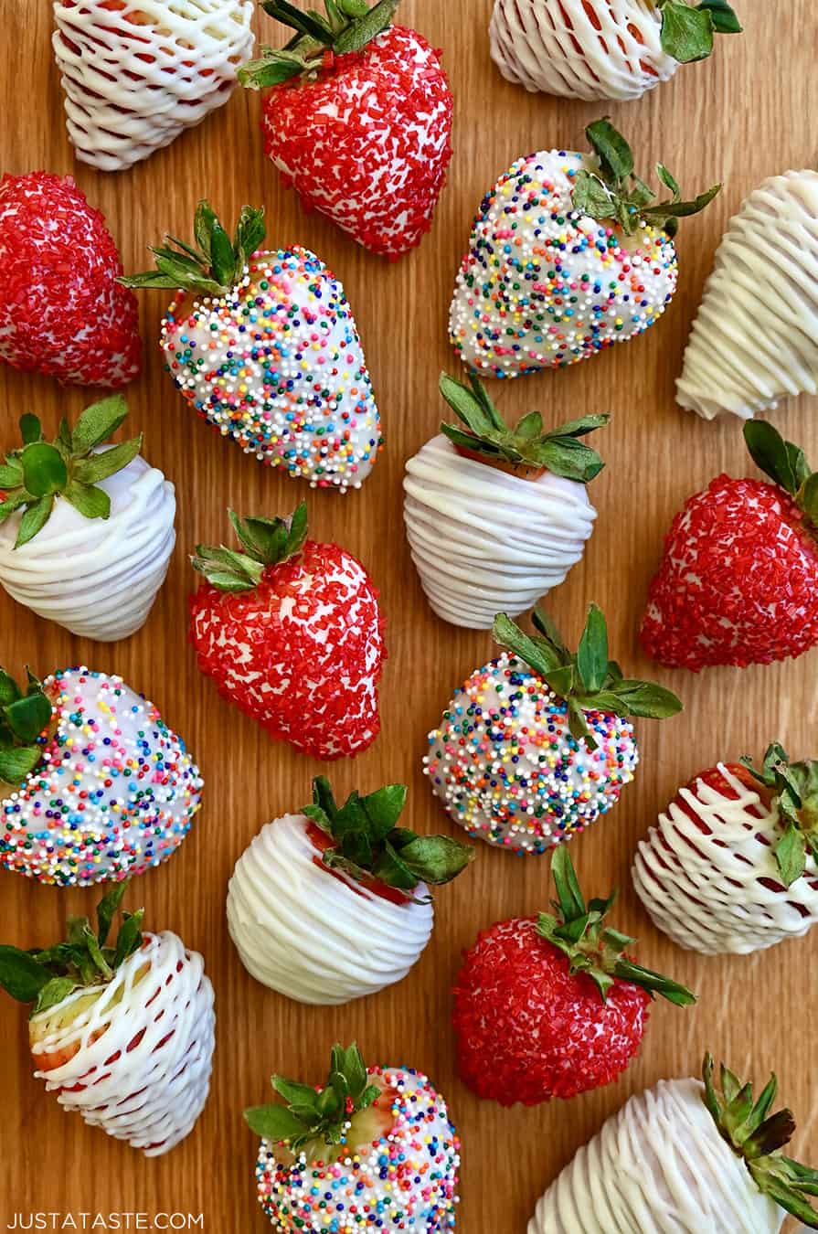 A top-down view of homemade White Chocolate-Covered Strawberries, including some decorated with rainbow sprinkles