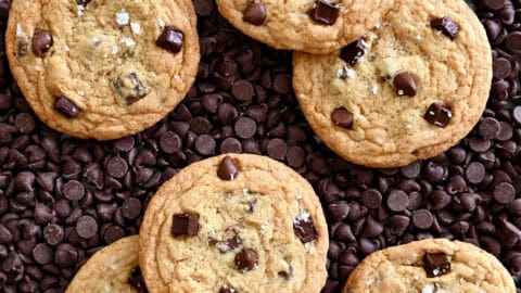 The best chewy chocolate chip cookies atop a bed of chocolate chips.