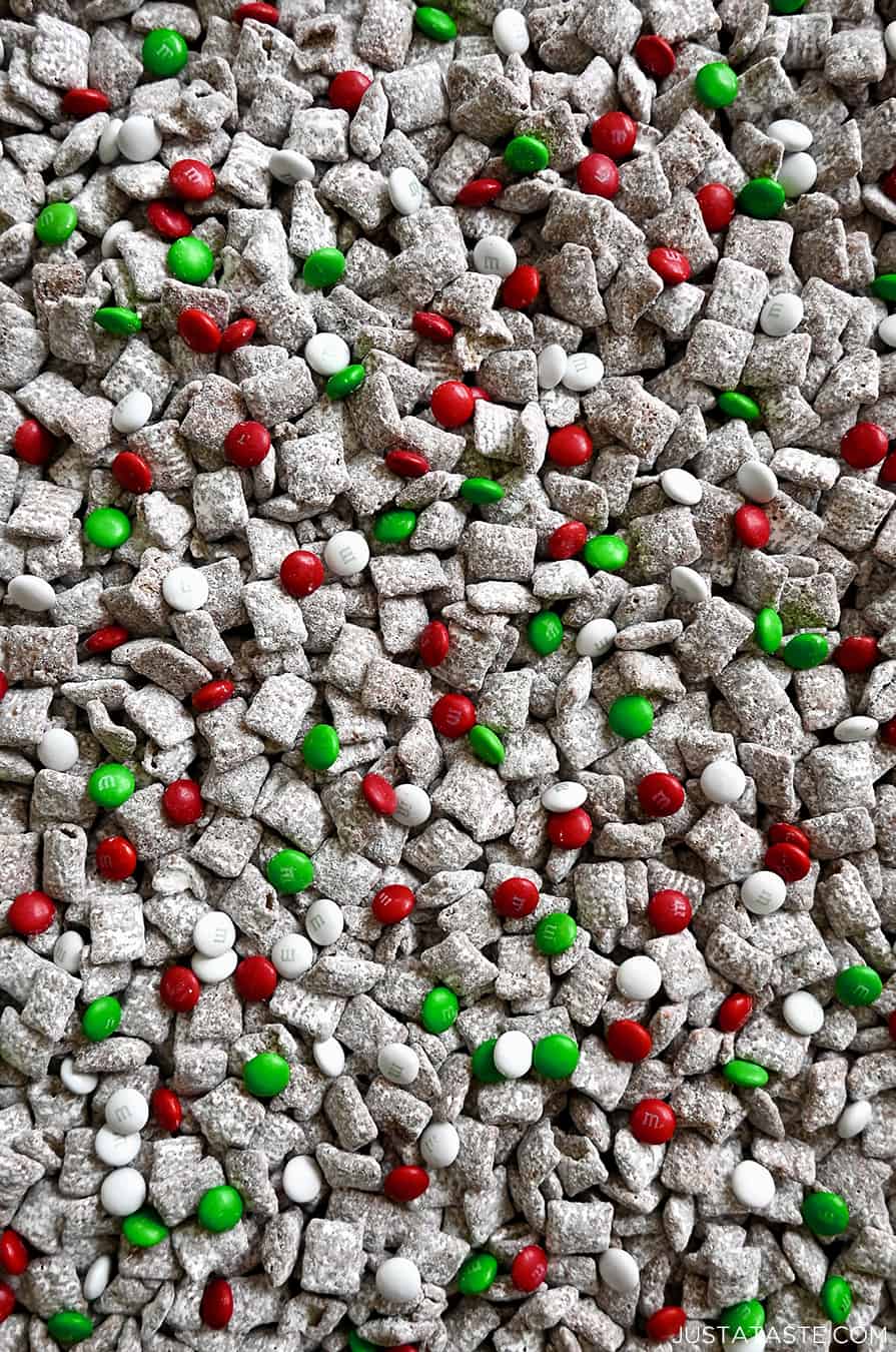 A close-up view of holiday Chex Mix with red, green and white M&Ms